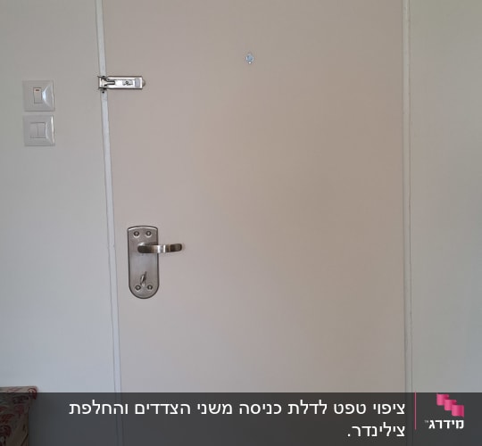 דלת לבנה עם ידית מתכת ובריח עליון